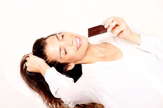 Portrait of a beautiful, latin Woman eating chocolate.