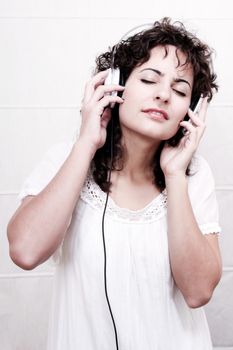 A young woman listening music with Headphones.