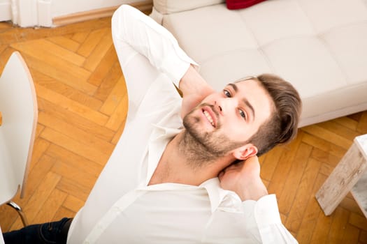 A young adult man relaxing and stretching his back.