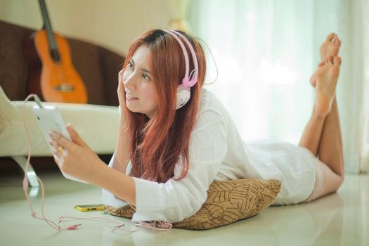 Young asian beautiful woman with smart phone and listening to music