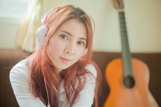 Young asian beautiful woman with smart phone and listening to music