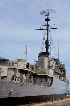 Retired old military ship with blue sky