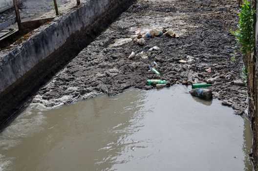 Urban city sewage waste water and garbage flow through first stage treatment plant equipment. Course bar screens.