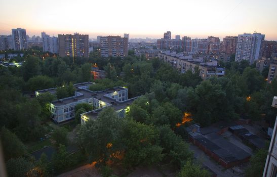 Moscow residental building and green trees in the evening