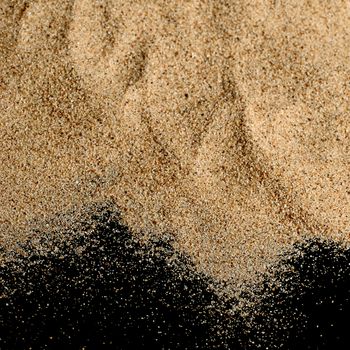 The sand on the black background close-up