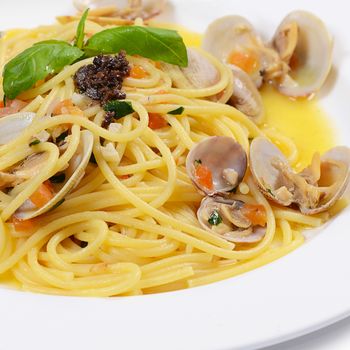 Spaghetti with mussels in bowls close up