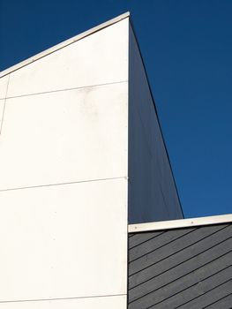 Modern abstract architecture in clear straight lines blue sky background