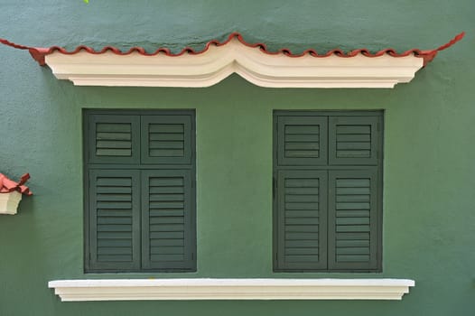 green twin windows in green background in Macau.