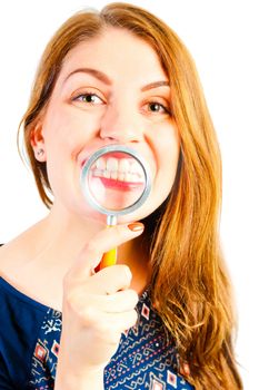 girl with magnifier showing his beautiful white teeth