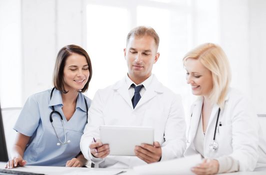 healthcare, medical and technology concept - doctors looking at tablet pc