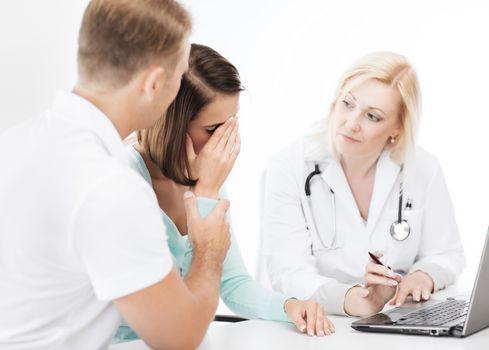 healthcare, medical and technology - doctor with patients looking at laptop