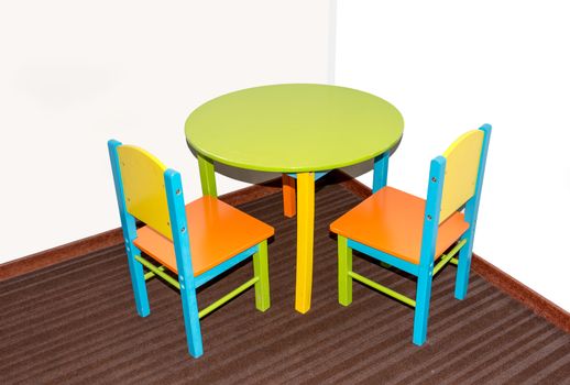 two small school chairs and table in fresh green blue and red
