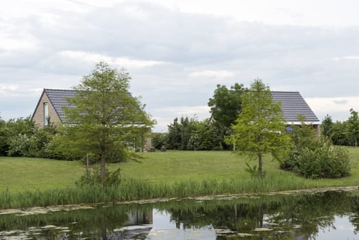 houses for holiday in nature with small lake in holland