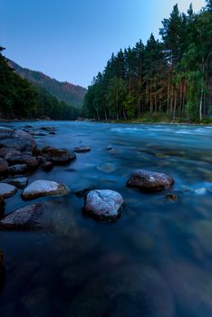 photographing flowing river early in the morning, Altai Krai