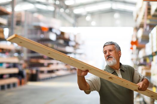 Man buying construction wood in a  DIY store for his DIY home re-modeling project