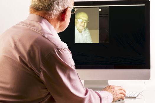 Man at computer on white background