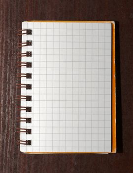 Notebook with square grid on a table