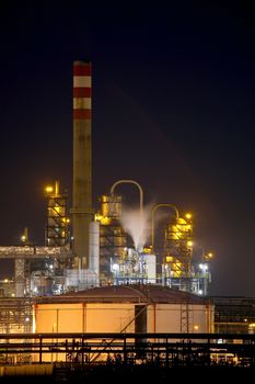 Oil refinery buildings at night