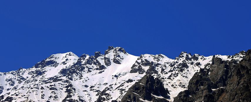 Caucasus mountains under snow and clear blue sky