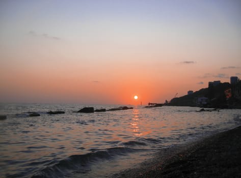 Sunset over summer sea with a small waves