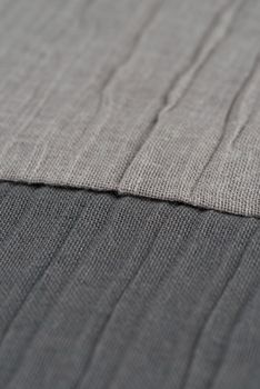 Closeup detail of grey fabric texture background.