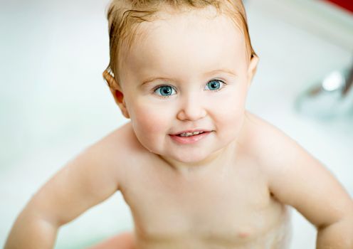 beautiful face of a little baby in the bathroom