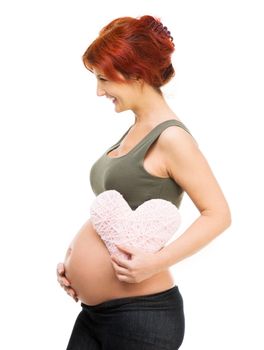 redhead pregnant woman holding pink heart isolated on white
