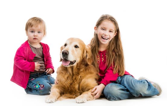 two cute little girls with a red retriever isolated on white background