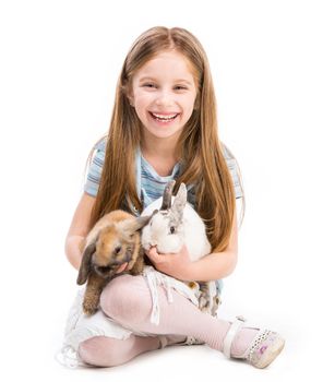 cute little girl with two Easter rabbits isolated on white background