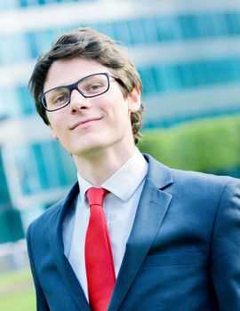 Outdoor portrait of a dynamic junior executive smiling