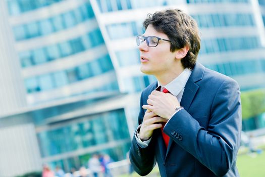 Outdoor portrait of a dynamic junior executive smiling