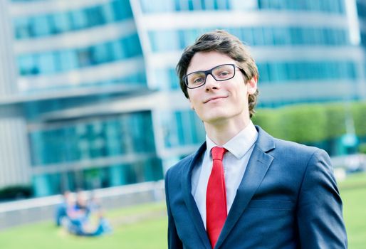 Outdoor portrait of a dynamic junior executive smiling
