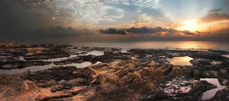 Sunset over the Sea and Rocky Coast