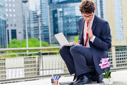 Junior executive dynamic working outside of his office