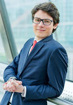 Outdoor portrait of a dynamic junior executive smiling