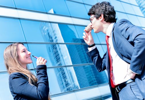 Nice portrait of young workers during coffee break with an electronic cigarette