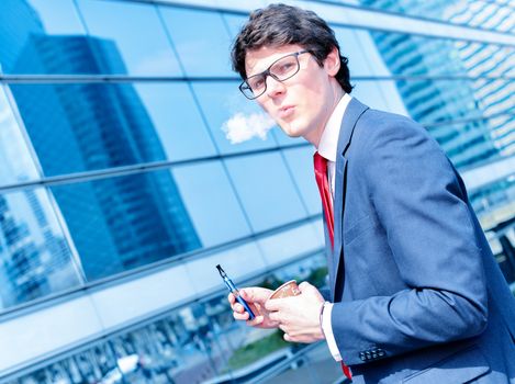 Nice portrait of young worker during coffee break with an electronic cigarette