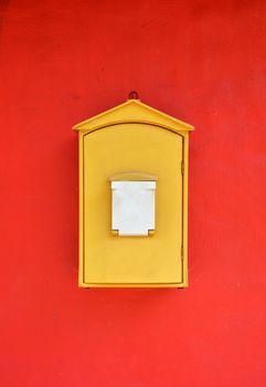 Yellow Decorated Mailbox on Red Background