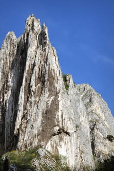 big limestone ridge over blue sky in Cheile Turzii, Romania