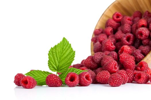 Fresh raspberries in wooden bowl on white background