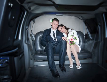 two loving people are sitting in a limousine wedding day