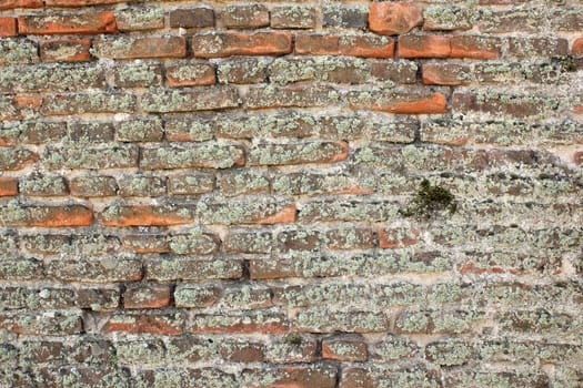 very old brick wall at exterior of ancient fortress

