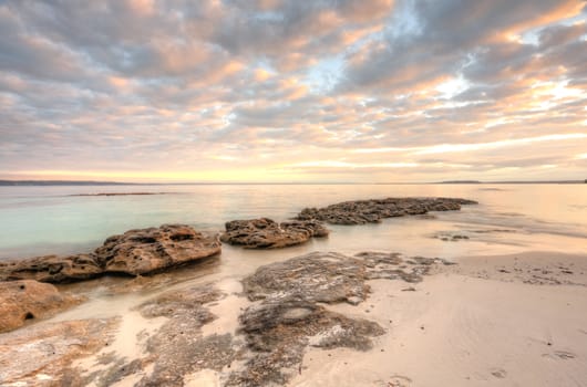 Pretty dappled skies over Scottish Rocks, Jervis Bay Australia at sunrise.