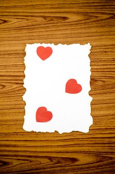 white paper and red heart on wooden background concept for valentine day