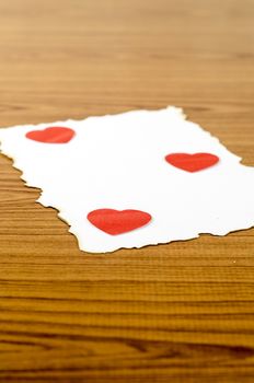 white paper and red heart on wooden background concept for valentine day