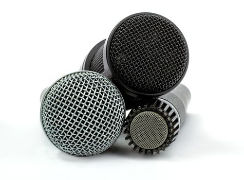 one condenser microphone and two dynamic microphones, isolated on white background