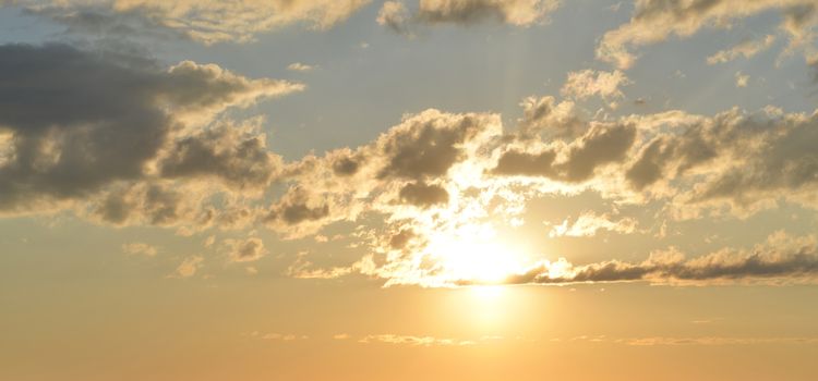 Evening blue sky. Clouds and sunset gold color