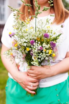 Woman holding wild flowers