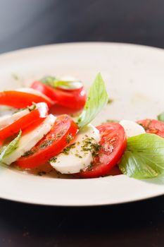 Tomato and mozzarella with basil leaves 