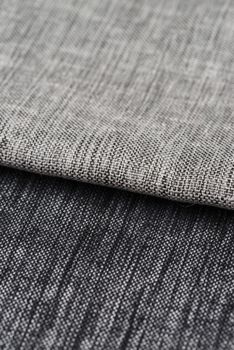 Closeup detail of grey fabric texture background.